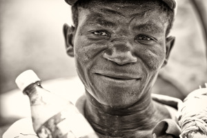 Man offering water on a hot day in Port au Prince Haiti