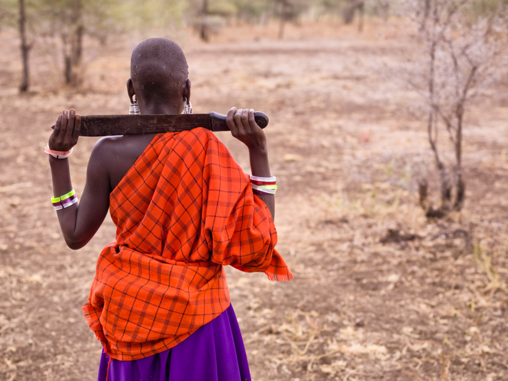 An image of a Maasai women getting ready to collect firewood for her family