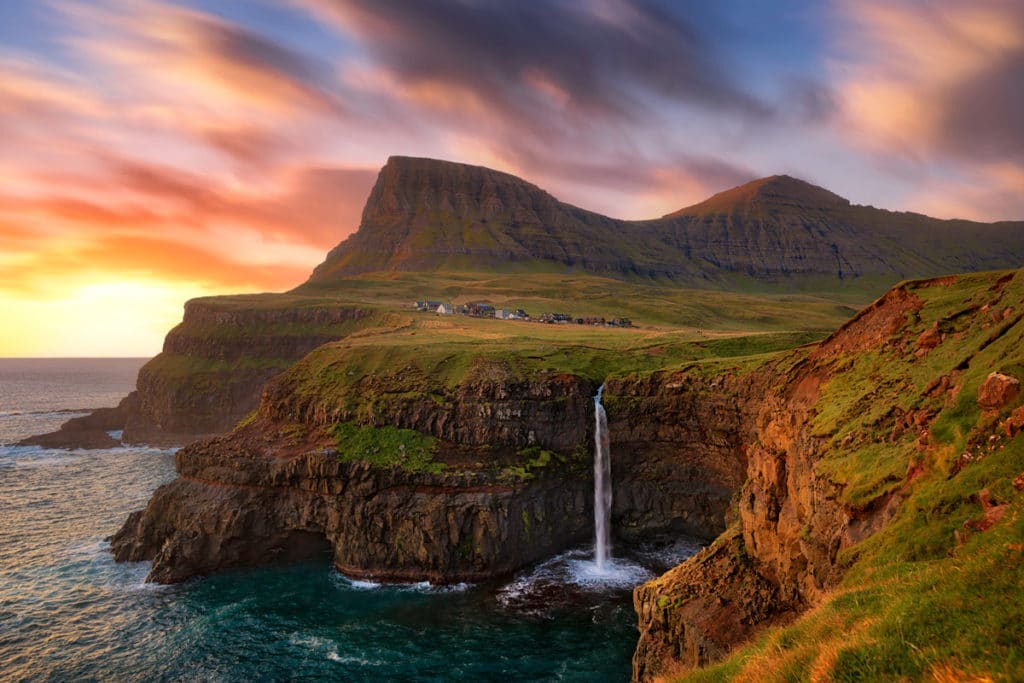 This is the Mulafossur Waterfall on the Faroe Islands - A Photography Workshop at Sunset with Colby Brown